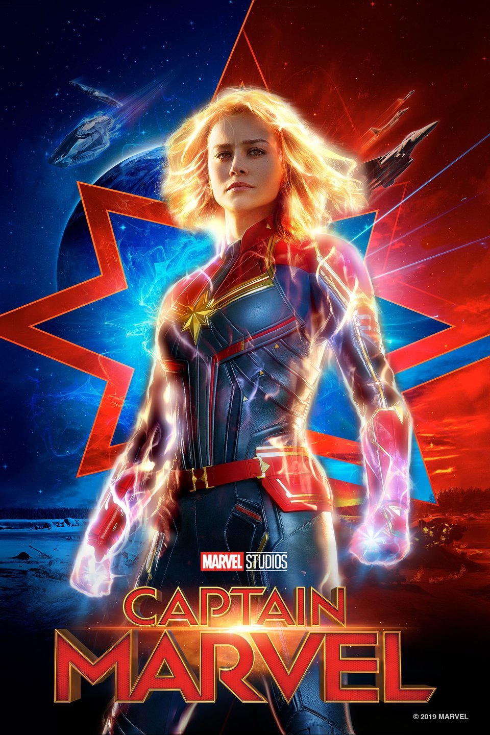 "Marvel Studios   Captain Marvel   ©2019 MARVEL" Blond woman wearing blue and red armor with gold star on chest, glowing arms and hair, blue and red background