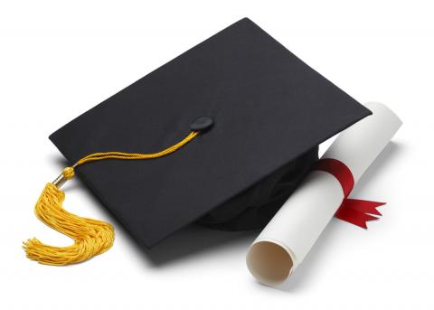 Blue graduation cap and white rolled diploma 